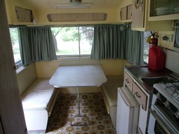 Inside Kookaburra, our 1960's onsite caravan, the table lets down to make a double bed. One of 4 onsite retro caravans at Grampians Paradise Camping and Caravan Parkland